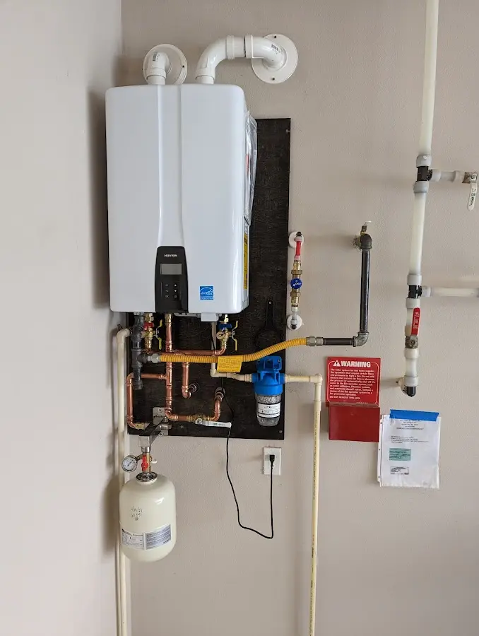 Professional plumber installing copper piping in a Colchester home